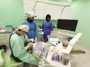 dentist-performing-treatment-with-two-nurse